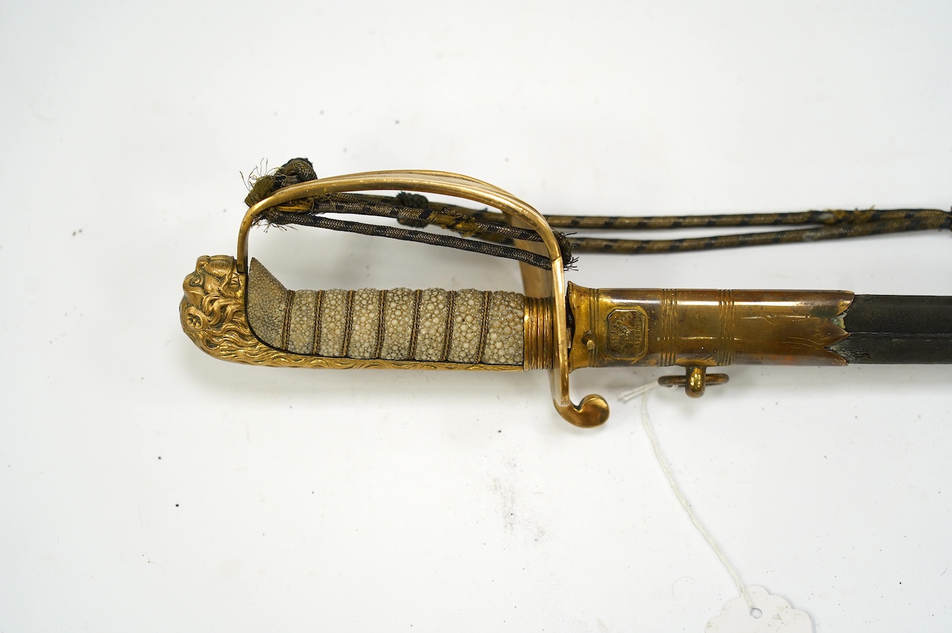 An unusual Victorian midshipman's sword, flat blade, regulation hilt with folding side guard, bullion dress knot, in its scabbard by Fraser and Davis, Portsmouth, blade 69cm. Condition - fair, well worn